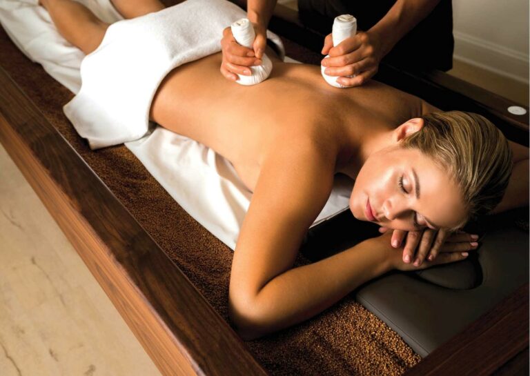 A lady on a massage bed at a spa in Cape Town experiencing Quartz Therapy treatment